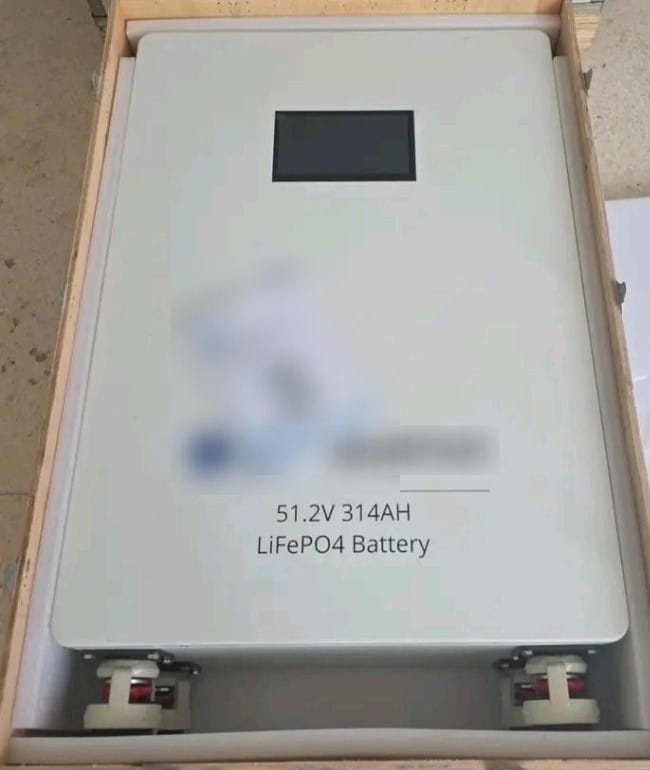 A 51.2 V, 314 Ah LiFePO4 lithium battery with a display, inside its wooden crate